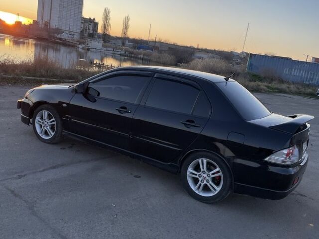 Черный Мицубиси Лансер, объемом двигателя 2 л и пробегом 50 тыс. км за 4500 $, фото 3 на Automoto.ua
