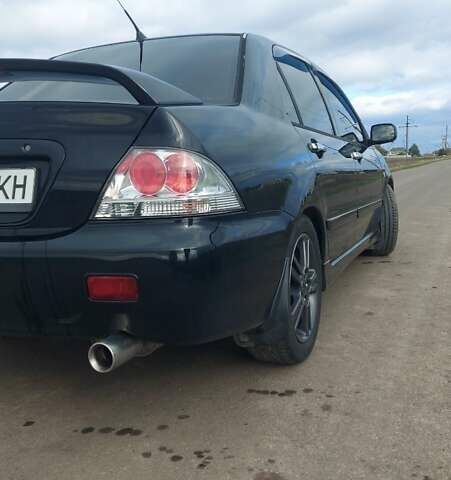 Черный Мицубиси Лансер, объемом двигателя 2 л и пробегом 225 тыс. км за 4400 $, фото 4 на Automoto.ua