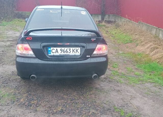 Черный Мицубиси Лансер, объемом двигателя 2 л и пробегом 270 тыс. км за 3200 $, фото 5 на Automoto.ua