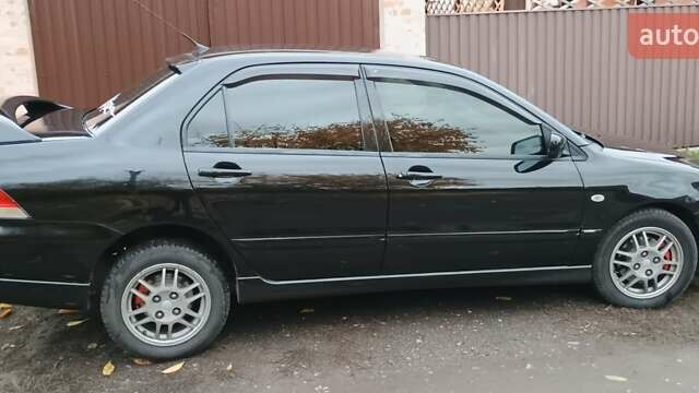 Черный Мицубиси Лансер, объемом двигателя 1.58 л и пробегом 261 тыс. км за 4400 $, фото 3 на Automoto.ua