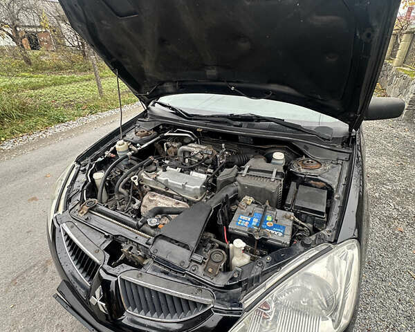 Черный Мицубиси Лансер, объемом двигателя 1.6 л и пробегом 200 тыс. км за 3499 $, фото 11 на Automoto.ua