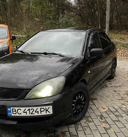 Черный Мицубиси Лансер, объемом двигателя 1.6 л и пробегом 200 тыс. км за 3000 $, фото 1 на Automoto.ua