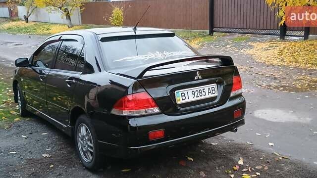 Черный Мицубиси Лансер, объемом двигателя 1.58 л и пробегом 261 тыс. км за 4400 $, фото 5 на Automoto.ua