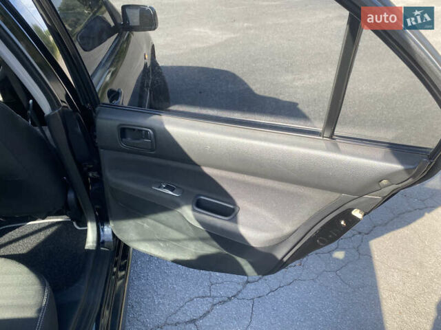Чорний Міцубісі Lancer, об'ємом двигуна 1.58 л та пробігом 236 тис. км за 4500 $, фото 12 на Automoto.ua