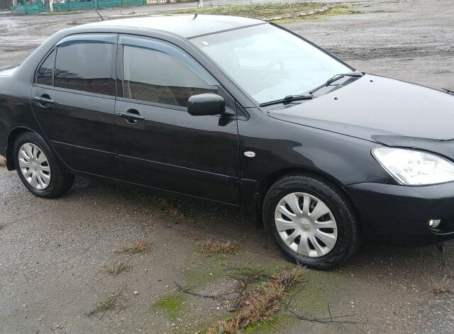 Черный Мицубиси Лансер, объемом двигателя 1.6 л и пробегом 230 тыс. км за 3250 $, фото 1 на Automoto.ua