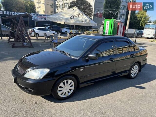 Черный Мицубиси Лансер, объемом двигателя 1.58 л и пробегом 171 тыс. км за 5000 $, фото 1 на Automoto.ua