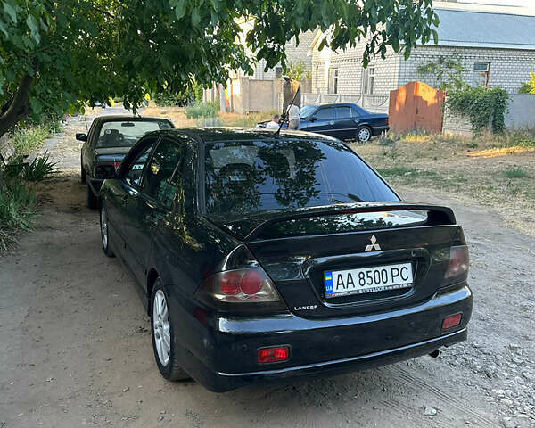 Черный Мицубиси Лансер, объемом двигателя 2 л и пробегом 255 тыс. км за 5000 $, фото 2 на Automoto.ua