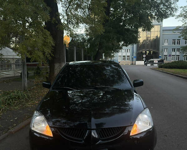 Черный Мицубиси Лансер, объемом двигателя 1.6 л и пробегом 233 тыс. км за 3650 $, фото 10 на Automoto.ua