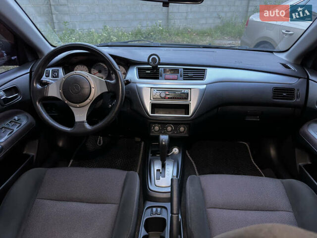 Черный Мицубиси Лансер, объемом двигателя 2 л и пробегом 255 тыс. км за 5000 $, фото 6 на Automoto.ua