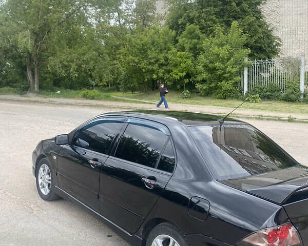 Чорний Міцубісі Lancer, об'ємом двигуна 2 л та пробігом 183 тис. км за 4500 $, фото 11 на Automoto.ua