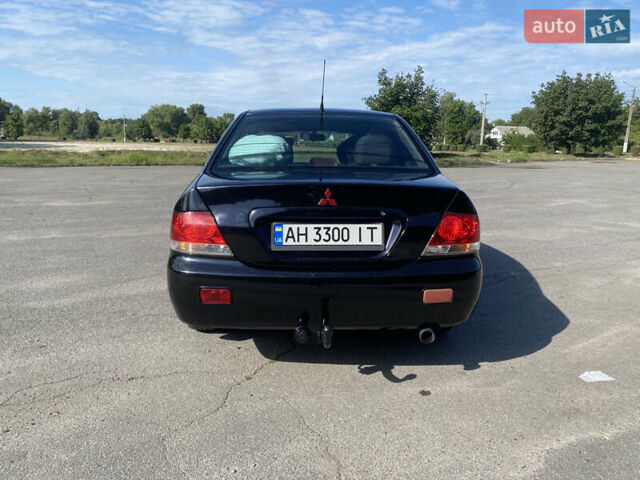 Чорний Міцубісі Lancer, об'ємом двигуна 1.58 л та пробігом 236 тис. км за 4500 $, фото 3 на Automoto.ua