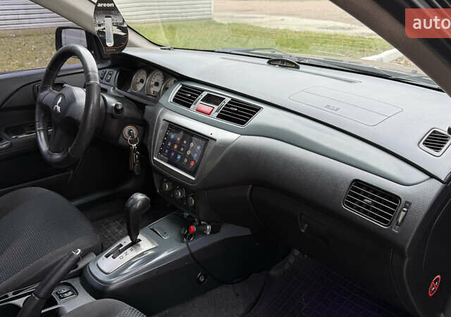 Чорний Міцубісі Lancer, об'ємом двигуна 1.58 л та пробігом 386 тис. км за 4450 $, фото 21 на Automoto.ua