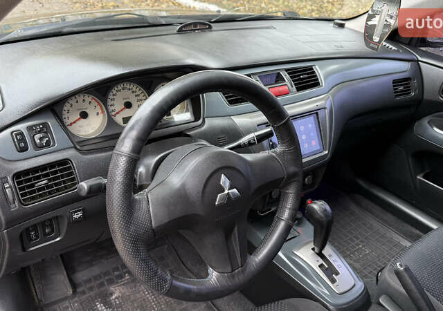 Чорний Міцубісі Lancer, об'ємом двигуна 1.58 л та пробігом 386 тис. км за 4450 $, фото 12 на Automoto.ua