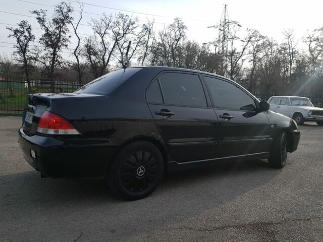 Черный Мицубиси Лансер, объемом двигателя 1.6 л и пробегом 290 тыс. км за 3200 $, фото 4 на Automoto.ua