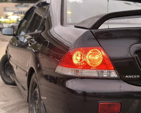 Чорний Міцубісі Lancer, об'ємом двигуна 1.58 л та пробігом 230 тис. км за 4350 $, фото 9 на Automoto.ua