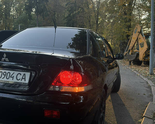 Черный Мицубиси Лансер, объемом двигателя 1.6 л и пробегом 233 тыс. км за 3650 $, фото 4 на Automoto.ua