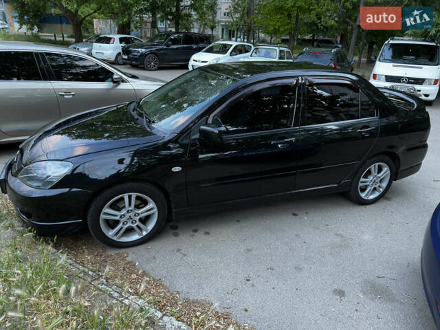Черный Мицубиси Лансер, объемом двигателя 2 л и пробегом 255 тыс. км за 5000 $, фото 4 на Automoto.ua