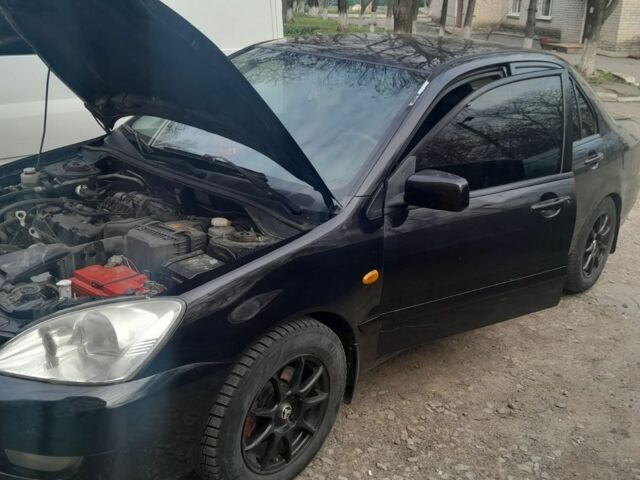 Черный Мицубиси Лансер, объемом двигателя 1.6 л и пробегом 260 тыс. км за 3800 $, фото 7 на Automoto.ua