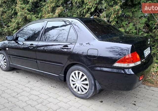 Черный Мицубиси Лансер, объемом двигателя 1.58 л и пробегом 246 тыс. км за 4200 $, фото 5 на Automoto.ua