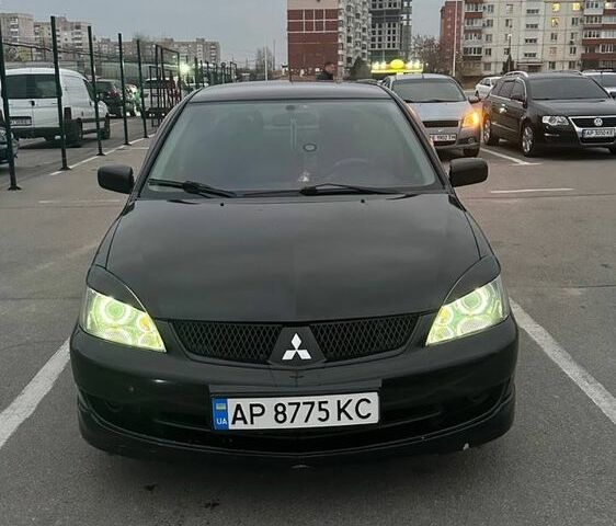 Черный Мицубиси Лансер, объемом двигателя 2 л и пробегом 238 тыс. км за 6000 $, фото 2 на Automoto.ua