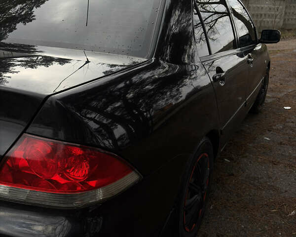 Чорний Міцубісі Lancer, об'ємом двигуна 1.58 л та пробігом 210 тис. км за 3900 $, фото 4 на Automoto.ua