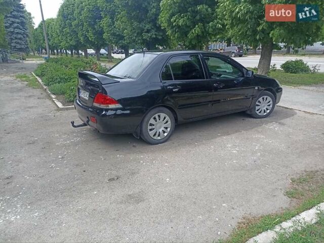 Черный Мицубиси Лансер, объемом двигателя 1.59 л и пробегом 243 тыс. км за 3750 $, фото 3 на Automoto.ua
