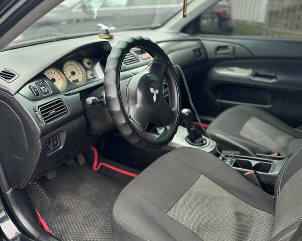 Черный Мицубиси Лансер, объемом двигателя 1.58 л и пробегом 370 тыс. км за 3500 $, фото 7 на Automoto.ua