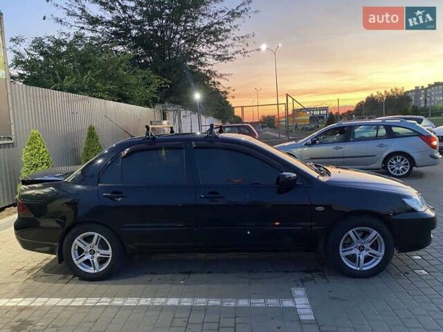 Черный Мицубиси Лансер, объемом двигателя 1.6 л и пробегом 257 тыс. км за 4500 $, фото 5 на Automoto.ua