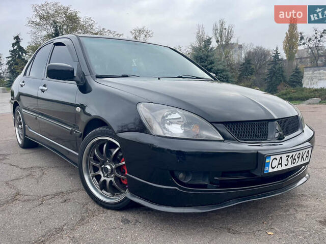 Чорний Міцубісі Lancer, об'ємом двигуна 2 л та пробігом 242 тис. км за 5900 $, фото 1 на Automoto.ua