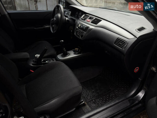 Чорний Міцубісі Lancer, об'ємом двигуна 1.58 л та пробігом 210 тис. км за 3900 $, фото 15 на Automoto.ua