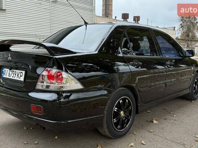 Чорний Міцубісі Lancer, об'ємом двигуна 1.58 л та пробігом 386 тис. км за 4450 $, фото 5 на Automoto.ua