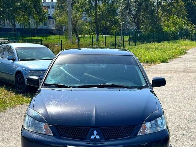 Черный Мицубиси Лансер, объемом двигателя 1.6 л и пробегом 230 тыс. км за 3200 $, фото 1 на Automoto.ua