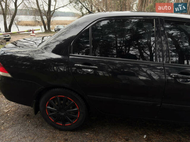 Чорний Міцубісі Lancer, об'ємом двигуна 1.58 л та пробігом 210 тис. км за 3900 $, фото 6 на Automoto.ua
