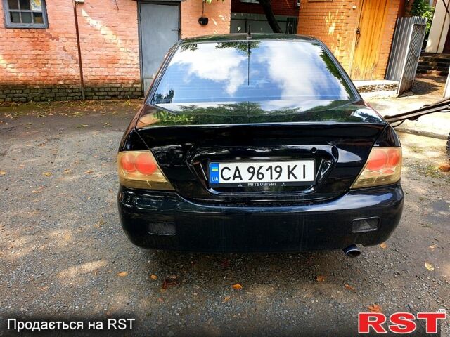 Черный Мицубиси Лансер, объемом двигателя 1.6 л и пробегом 230 тыс. км за 4200 $, фото 1 на Automoto.ua