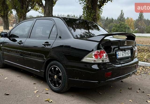 Чорний Міцубісі Lancer, об'ємом двигуна 1.58 л та пробігом 386 тис. км за 4450 $, фото 3 на Automoto.ua
