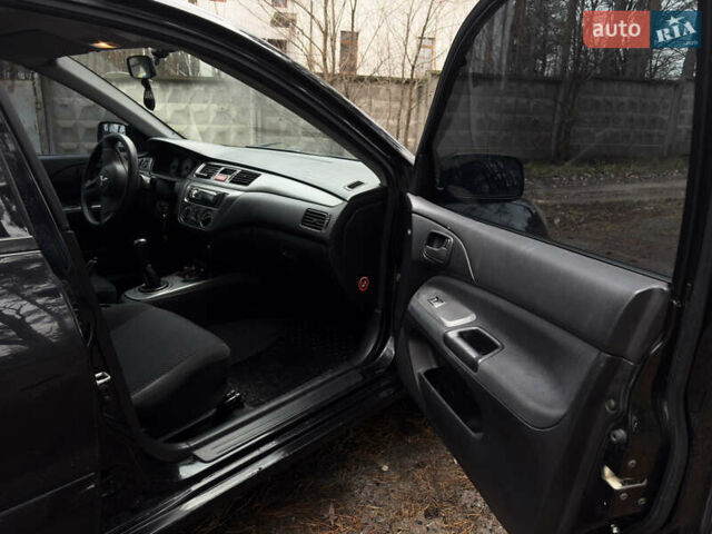 Чорний Міцубісі Lancer, об'ємом двигуна 1.58 л та пробігом 210 тис. км за 3900 $, фото 14 на Automoto.ua