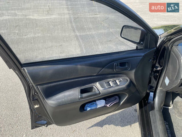Чорний Міцубісі Lancer, об'ємом двигуна 1.58 л та пробігом 236 тис. км за 4500 $, фото 6 на Automoto.ua