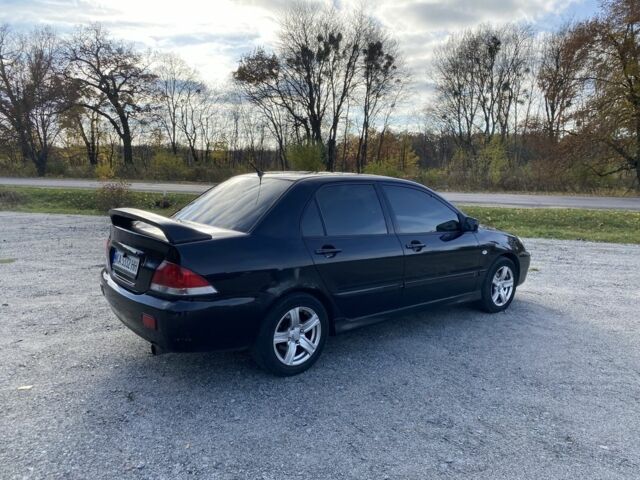 Черный Мицубиси Лансер, объемом двигателя 1.6 л и пробегом 200 тыс. км за 3400 $, фото 2 на Automoto.ua