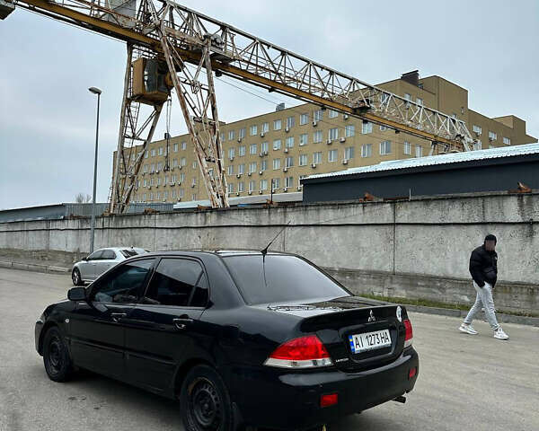 Чорний Міцубісі Lancer, об'ємом двигуна 1.58 л та пробігом 237 тис. км за 3800 $, фото 1 на Automoto.ua