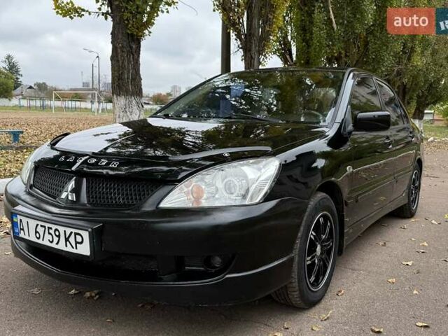 Чорний Міцубісі Lancer, об'ємом двигуна 1.58 л та пробігом 386 тис. км за 4450 $, фото 1 на Automoto.ua