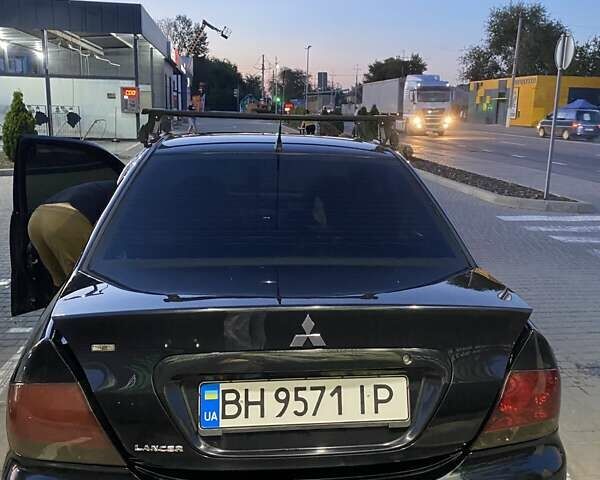 Черный Мицубиси Лансер, объемом двигателя 1.6 л и пробегом 257 тыс. км за 4500 $, фото 6 на Automoto.ua