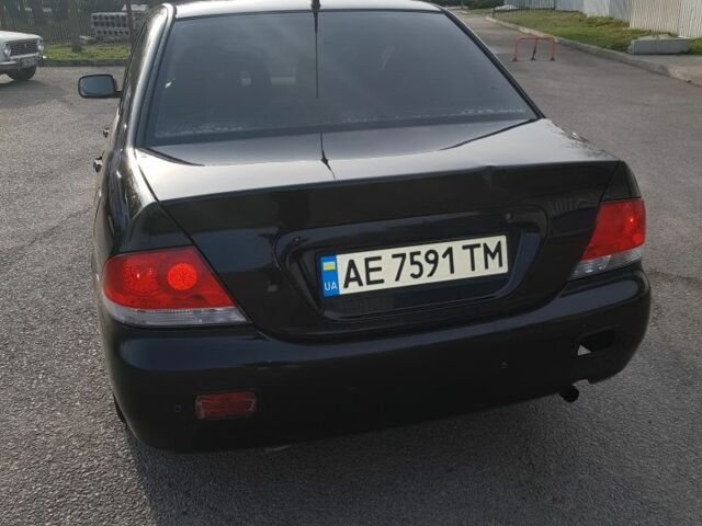 Черный Мицубиси Лансер, объемом двигателя 1.6 л и пробегом 290 тыс. км за 3200 $, фото 3 на Automoto.ua