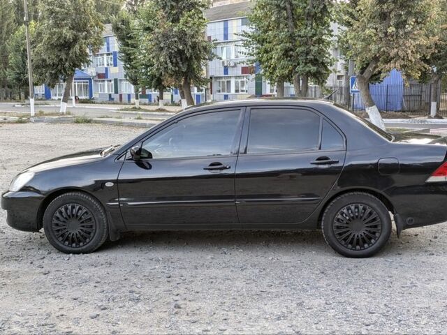 Черный Мицубиси Лансер, объемом двигателя 1.6 л и пробегом 226 тыс. км за 4800 $, фото 5 на Automoto.ua