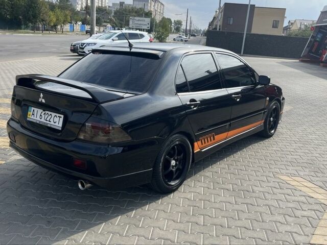 Черный Мицубиси Лансер, объемом двигателя 2 л и пробегом 224 тыс. км за 5800 $, фото 2 на Automoto.ua