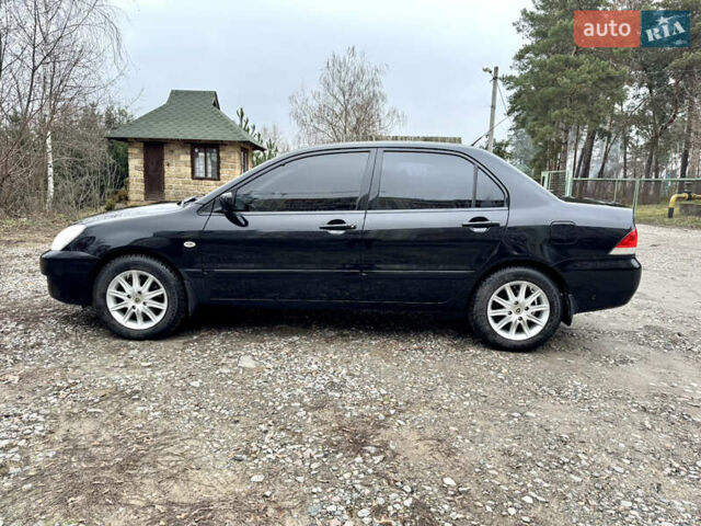 Черный Мицубиси Лансер, объемом двигателя 1.6 л и пробегом 216 тыс. км за 4990 $, фото 1 на Automoto.ua