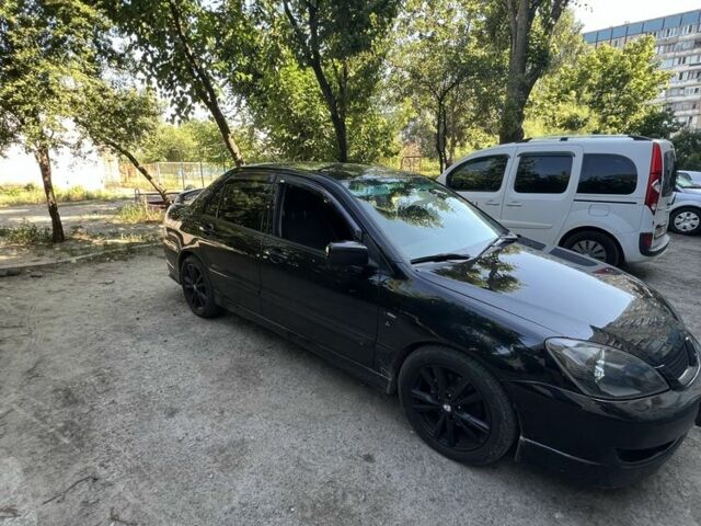 Черный Мицубиси Лансер, объемом двигателя 2 л и пробегом 240 тыс. км за 5600 $, фото 2 на Automoto.ua