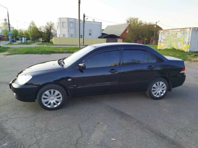 Черный Мицубиси Лансер, объемом двигателя 1.6 л и пробегом 32 тыс. км за 9000 $, фото 2 на Automoto.ua