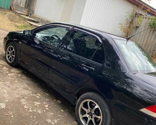 Чорний Міцубісі Lancer, об'ємом двигуна 1.58 л та пробігом 231 тис. км за 4300 $, фото 6 на Automoto.ua