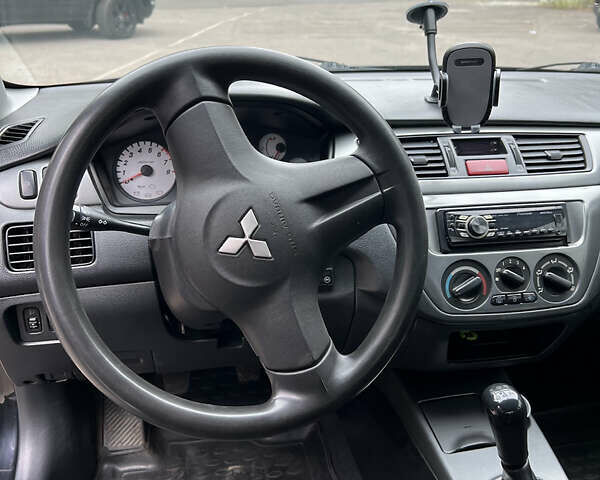 Чорний Міцубісі Lancer, об'ємом двигуна 1.58 л та пробігом 256 тис. км за 4200 $, фото 11 на Automoto.ua