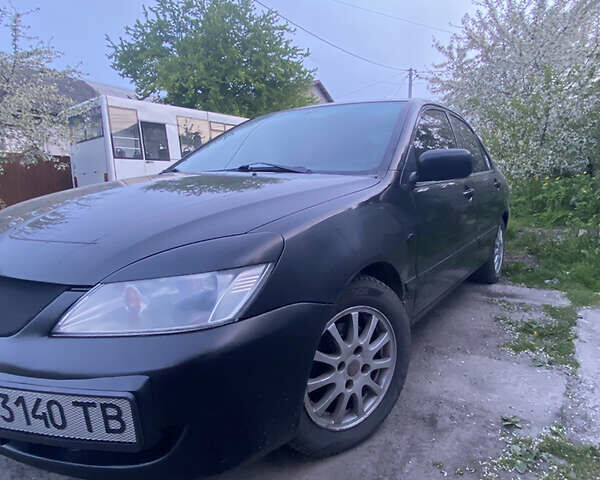 Чорний Міцубісі Lancer, об'ємом двигуна 1.6 л та пробігом 195 тис. км за 5200 $, фото 28 на Automoto.ua